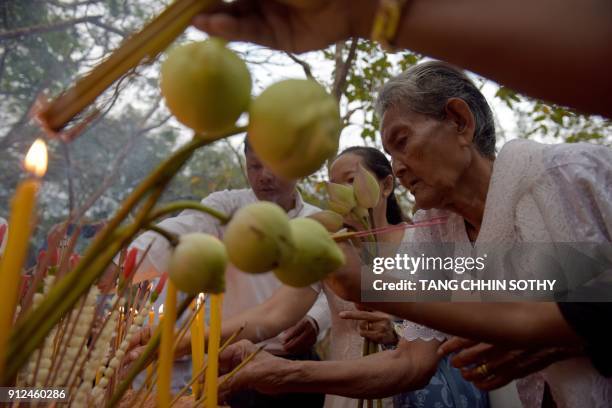 Cambodians burn incense sticks during the Meak Bochea Buddhist celebration at the Oddong mountain in Kandal province, some 40 kilometers north of...