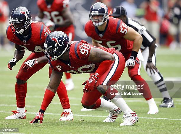 Defensive end Mario Williams, Antonio Smith and linebacker Brian Cushing of the Houston Texans line up defensively during the game against the...