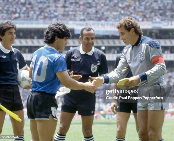 England captain Peter Shilton shakes hands with Diego Maradona of Argentina, watched by referee Ali Bennaceur prior to the FIFA World Cup quarter...