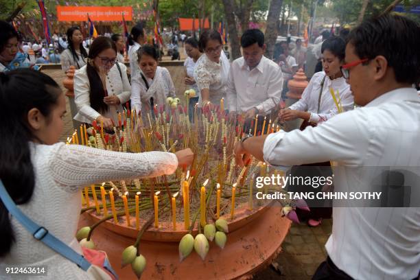 Cambodian people burn incense sticks during the Meak Bochea Buddhist celebration at the Oddong mountain in Kandal province, some 40 kilometers north...