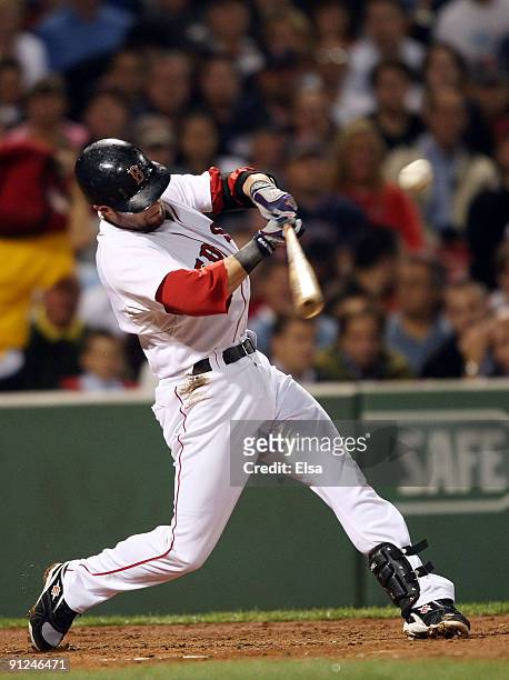 Dustin Pedroia of the Boston Red Sox hits a double in the first inning against the Toronto Blue Jays on September 29, 2009 at Fenway Park in Boston,...