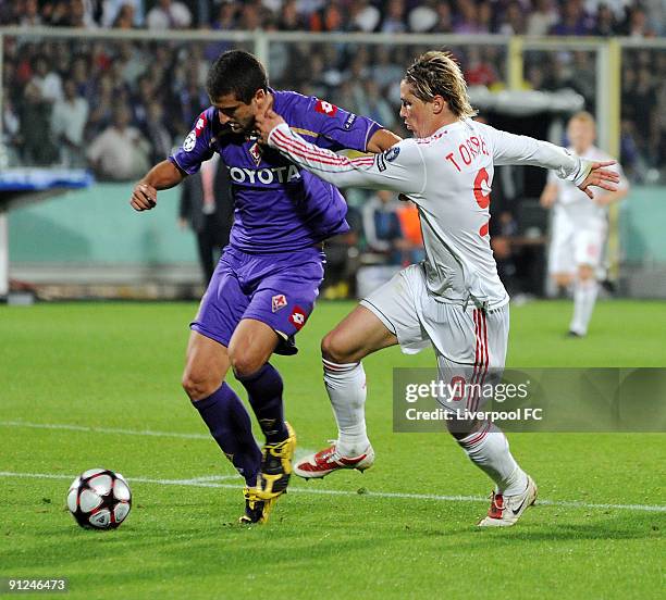 Fernando Torres of Liverpool competes with Alessandro Gamberini of Fiorentina during the UEFA Champions League group E match between Fiorentina and...