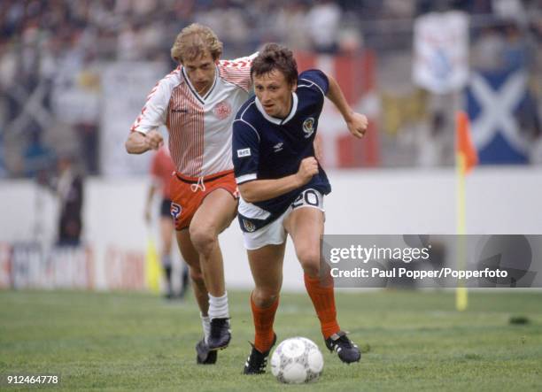 Paul Sturrock of Scotland is chased by Denmark's Soren Buck during the FIFA World Cup match between Scotland and Denmark at the Estadio Neza in...