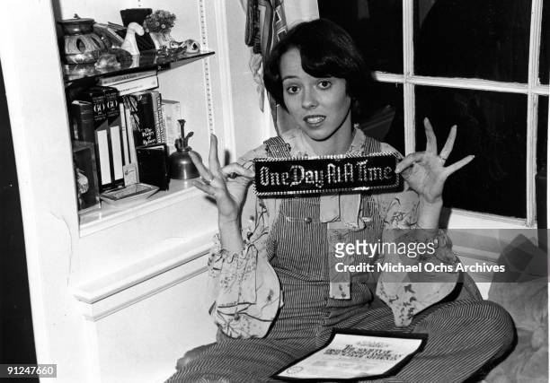 Actress Mackenzie Phillips poses for a portrait session at home holding a bumper sticker that reads "One Day At A Time" on December 3, 1976 in Los...