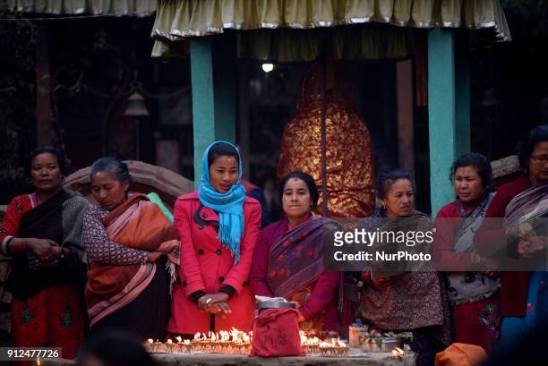 Nepalese Hindu devotees offering butter lamps during Last Day of Madhav Narayan Festival or Swasthani Brata Katha festival at Hanumante River,...