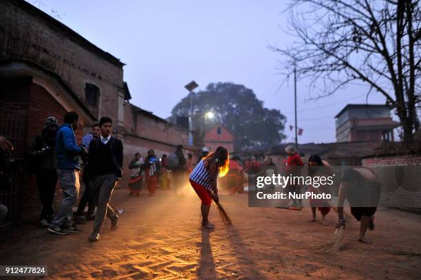 Nepalese Hindu devotees cleans gound for rolling procession arounds the Hanumante River during Last Day of Madhav Narayan Festival or Swasthani Brata...