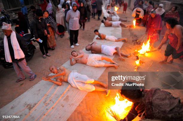 Nepalese Hindu devotees rolling procession around the Hanumante River during Last Day of Madhav Narayan Festival or Swasthani Brata Katha festival at...