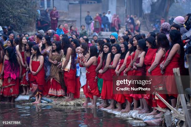 Nepalese Hindu devotees arrive to take holy Bath during Last Day of Madhav Narayan Festival or Swasthani Brata Katha festival at Hanumante River,...