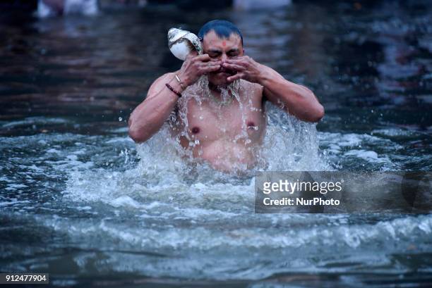 Nepalese Hindu devotee takes holy Bath during Last Day of Madhav Narayan Festival or Swasthani Brata Katha festival at Hanumante River, Bhaktapur,...