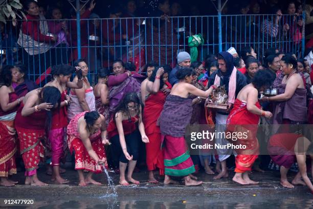 Nepalese Hindu devotees offering ritual prayer during Last Day of Madhav Narayan Festival or Swasthani Brata Katha festival at Hanumante River,...