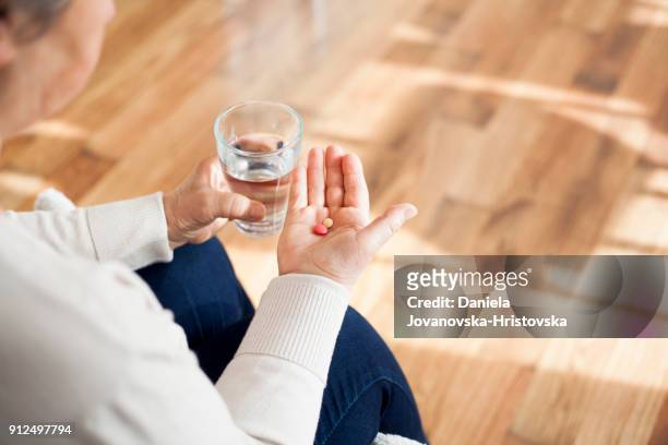 senior woman taking pills - taking pill stock pictures, royalty-free photos & images
