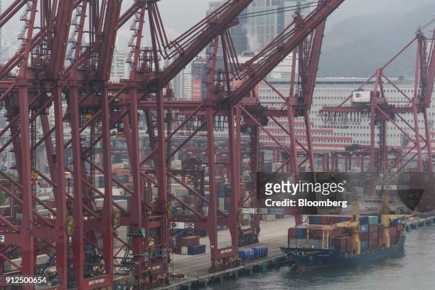 Container ship sits moored next to gantry canes in Container Terminal 9, operated by Hong Kong International Terminal - a unit of CK Hutchison...