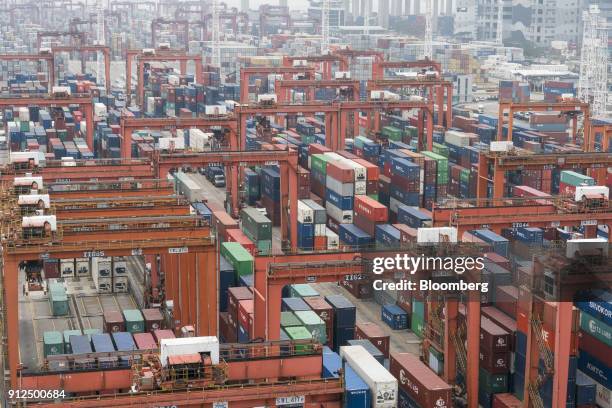 Shipping containers sit stacked among remote-controlled gantry cranes in Container Terminal 9, operated by Hong Kong International Terminal - a unit...