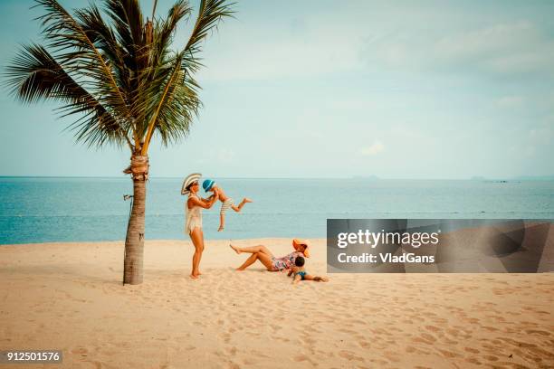 woman with baby on the beach - child palm of hand stock pictures, royalty-free photos & images