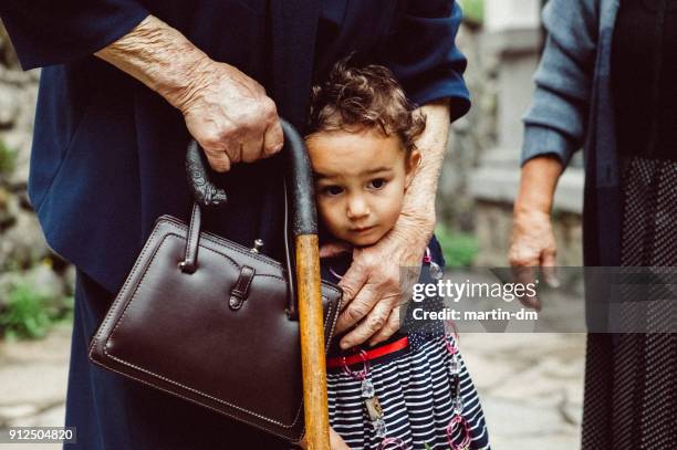 liten flicka med mormor utanför - grandma cane bildbanksfoton och bilder