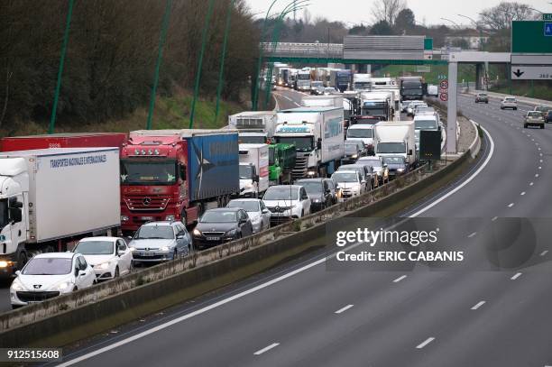 Transport trucks and cars are jammed on January 31, 2018 on the Toulouse ring road during a go-slow operation called by farmers union FDSEA...