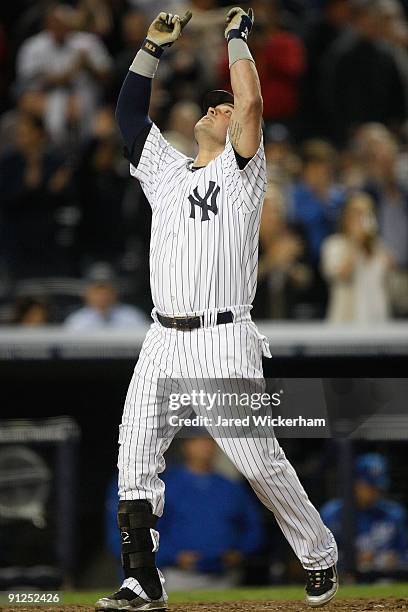 Nick Swisher of the New York Yankees celebrates at home plate after hitting a solo home run in the 7th inning against the Kansas City Royals during...