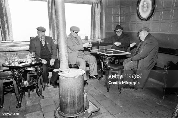 Group of men play dominoes at the Druids Head Inn in Coseley, a suburban area in the north of the Dudley, The Black Country, an area of the West...