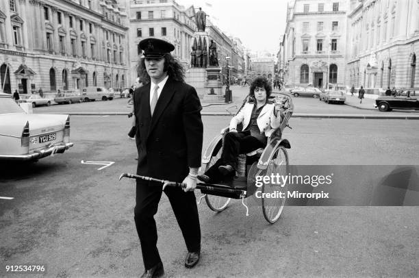 Singer Marc Bolan in a rickshaw in London. Drawing the rickshaw is Alphie O'Leary, Marc's chauffeur, 12th December 1973.