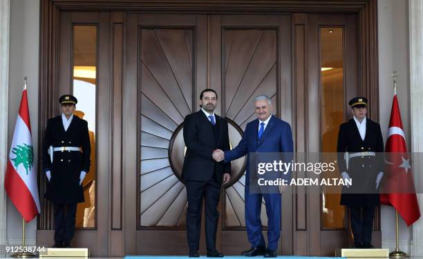 Lebanese Prime Minister Saad Hariri shakes hands with Turkish Prime Minister Binali Yildirim with an official ceremony during his visit at Cankaya...