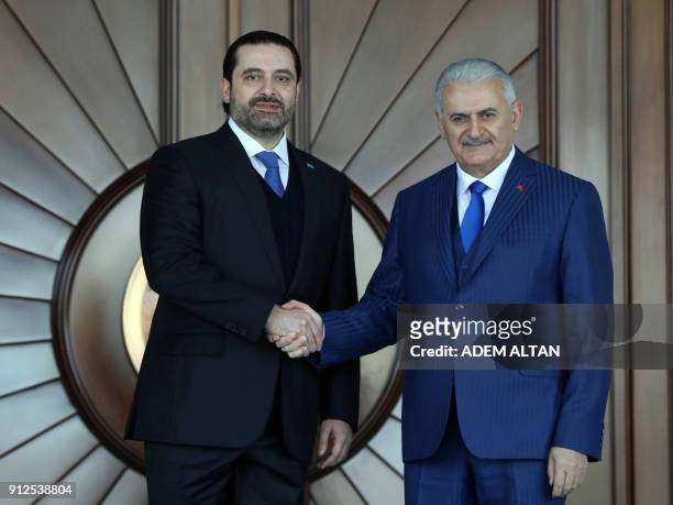 Lebanese Prime Minister Saad Hariri shakes hands with Turkish Prime Minister Binali Yildirim with an official ceremony during his visit at Cankaya...