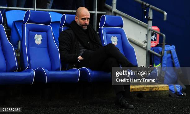 Pep Guardiola, manager of Manchester City looks on during The Emirates FA Cup Fourth Round match between Cardiff City and Manchester City at the...