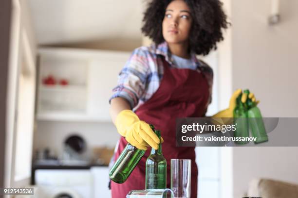 young woman cleaning kitchen - cleaning after party stock pictures, royalty-free photos & images