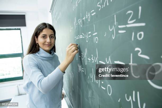 female student writing mathematical formula - high school maths stock pictures, royalty-free photos & images