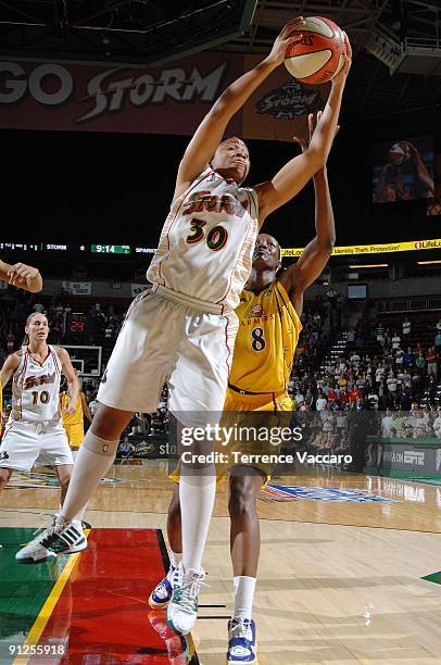 Tanisha Wright of the Seattle Storm grabs a rebound against DeLisha Milton-Jones of the Los Angeles Sparks in Game Three of the Western Conference...