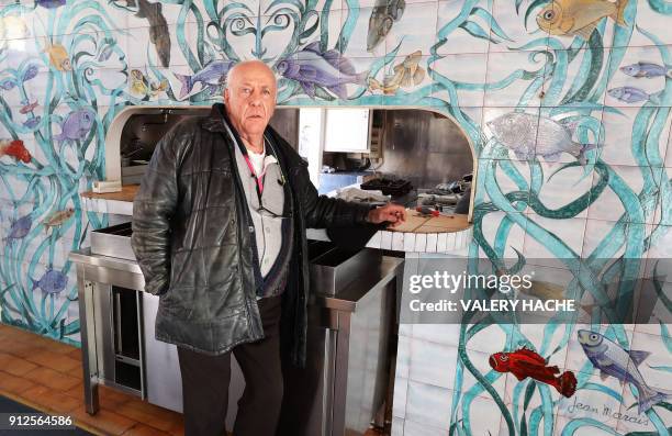 Gilles Esmiol poses in front of a fresco, painted by French sculptor Jean Marais and listed as a historical monument, in his restaurant "Nounou", one...