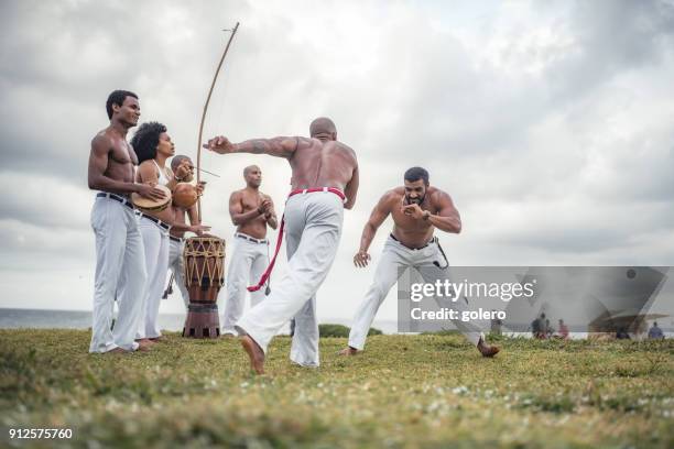 capoeira fight at beach of salvador brazil - salvador bahia stock pictures, royalty-free photos & images