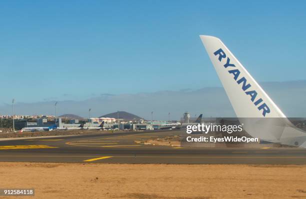 Take-off of a Ryanair jet with tourists from the Reina Sofia Airport Tenerife with panoramic island view on volcano Teide on January 19, 2018 in El...