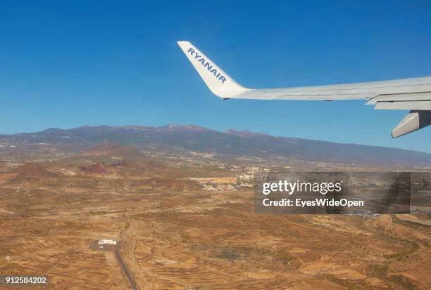 Take-off of a Ryanair jet with tourists from the Reina Sofia Airport Tenerife with panoramic island view on volcano Teide on January 19, 2018 in El...