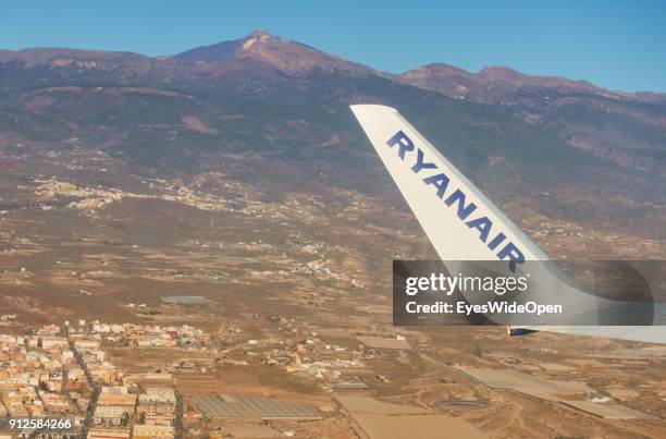 Take-off of a Ryanair jet with tourists from the Reina Sofia Airport Tenerife with panoramic island view on volcano Teide on January 19, 2018 in El...