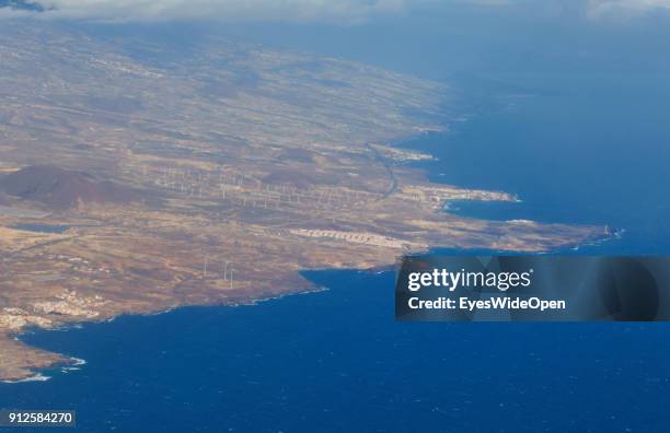 Take-off of a Ryanair jet with tourists from the Reina Sofia Airport Tenerife with panoramic island view on the energy windpark with wind turbines on...