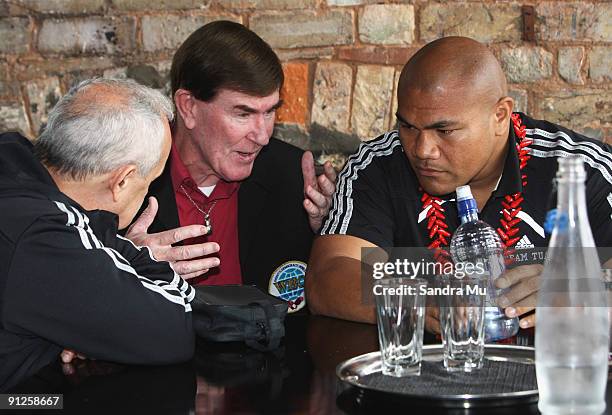 David Tua talks with referee Bruce McTavish and trainer Roger Bloodworth before a Press Conference ahead of his fight against Shane Cameron on...