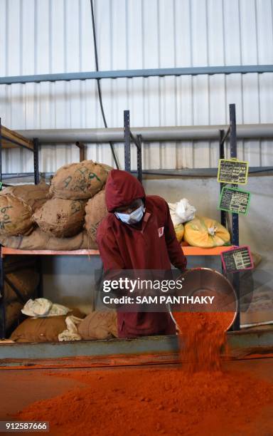 Indian workers pack chilli powder at Hearty Mart Food Product Manufacturers & Packers on the outskirts of Dholka on January 31, 2018. The Indian...