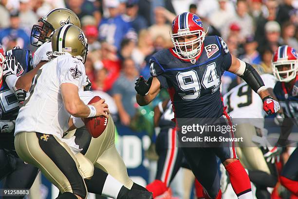 Aaron Schobel of the Buffalo Bills rushes quarterback Drew Brees of the New Orleans Saints at Ralph Wilson Stadium on September 27, 2009 in Orchard...