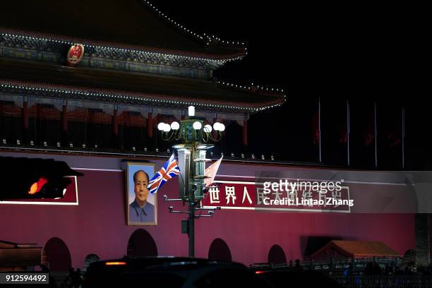 The national flags of Britain and China fly outside the Forbidden City after a welcome ceremony for British Prime Minister Theresa May on January 31,...