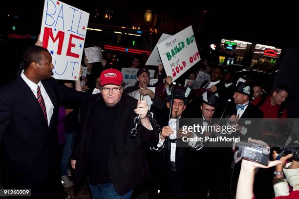 Director Michael Moore arrives with actors portraying the CEOs of three banks that received bailout money at the "Capitalism: A Love Story" premiere...