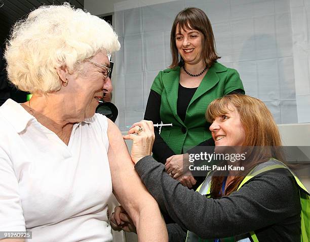 The Minister for Health and Ageing Nicola Roxon looks on as a nurse administers the H1N1 vaccine to an elderly lady during the launch of the National...