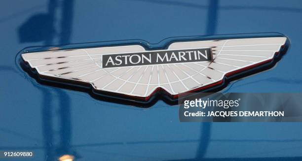 The logo on an Aston Martin "Vanquish S" is displayed at The International Automobile Festival in Paris on January 31, 2018. / AFP PHOTO / JACQUES...