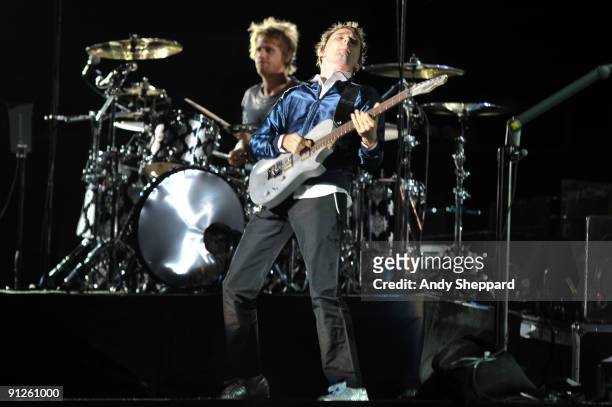 Dominic Howard and Matt Bellamy of Muse perform on stage at FedExField on September 29, 2009 in Landover, Maryland.