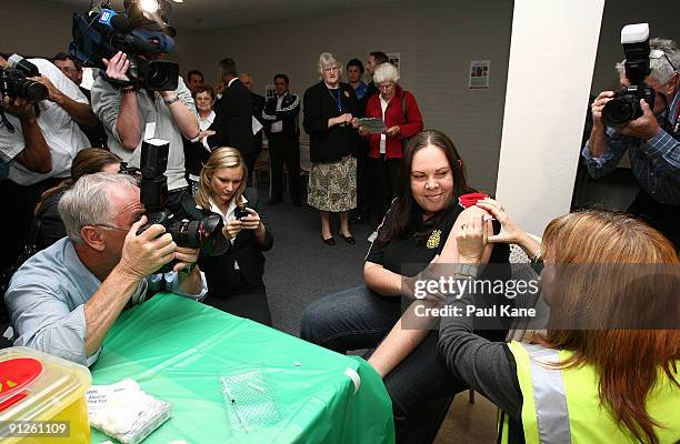 Young woman is immunised with the Panvax H1N1 Vaccine by a nurse during the launch of the National pandemic influenza vaccination campaign by the...