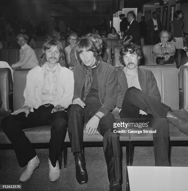 British musicians Richard Wright , Roger Waters, and Nick Mason of rock group Pink Floyd at Heathrow Airport before leaving for a 22-date US tour,...