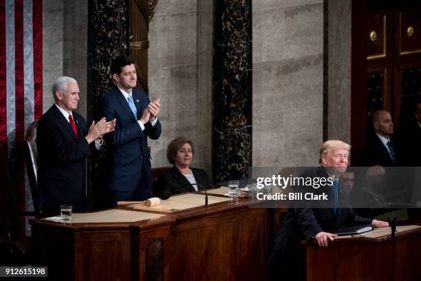 From left, Vice President Mike Pence and Speaker of the House Paul Ryan, R-Wisc., clap as President Donald Trump speaks during the joint session of...