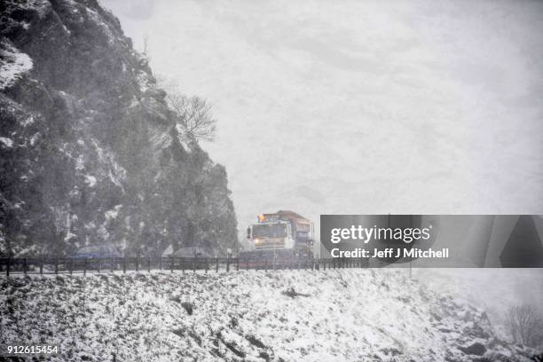 Snow plough spreads grit on the A83 Rest and Be Thankful as wintery conditions return on January 31, 2018 in Arrochar, Scotland. Motorists were...