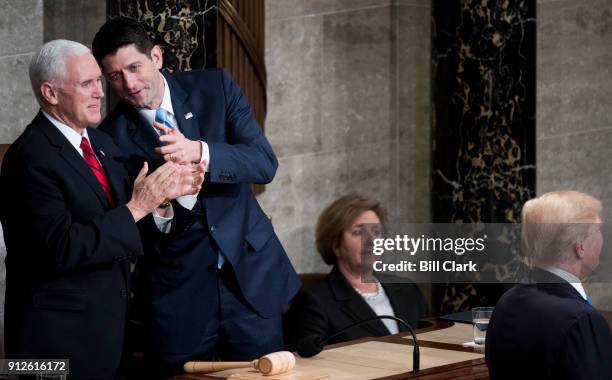 From left, Vice President Mike Pence and Speaker of the House Paul Ryan, R-Wisc., talk as President Donald Trump speaks during the joint session of...