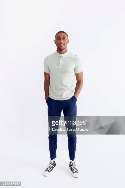 young man standing - abbigliamento casual foto e immagini stock