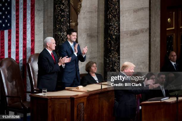 From left, Vice President Mike Pence and Speaker of the House Paul Ryan, R-Wisc., clap as President Donald Trump speaks during the joint session of...